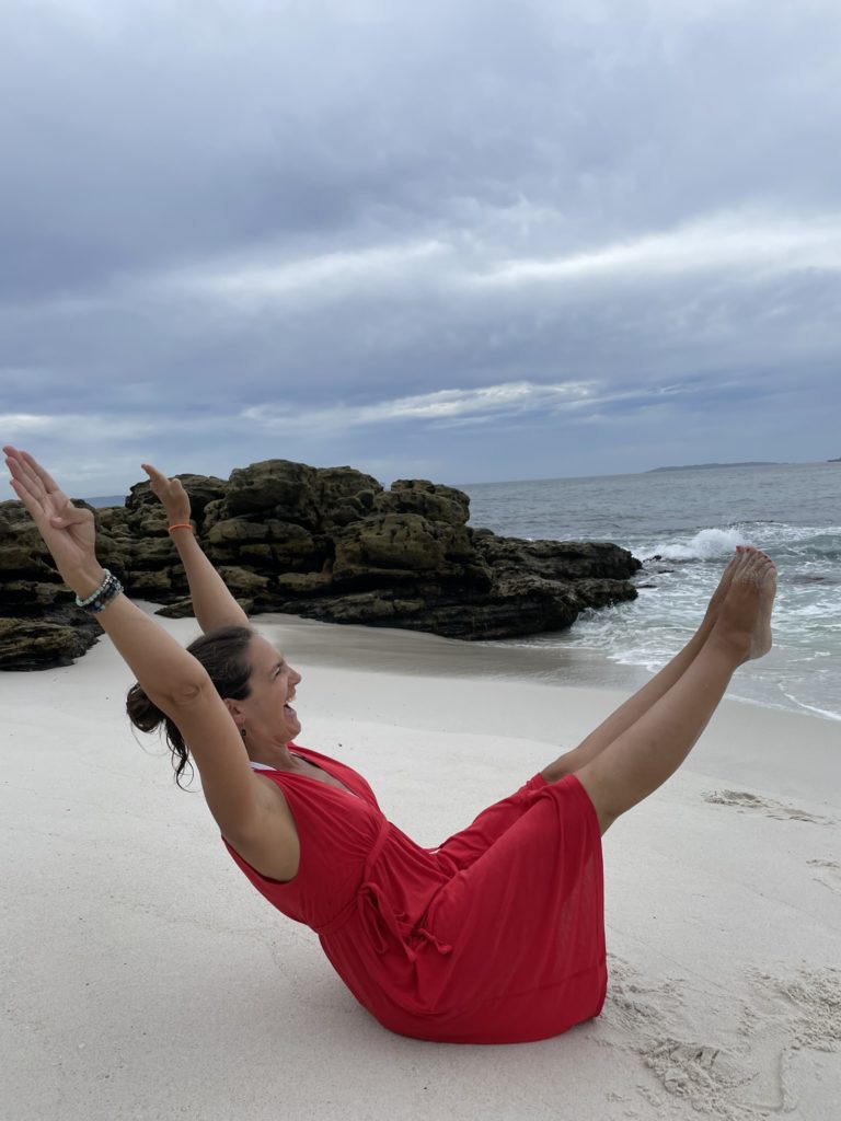Having fun doing pilates on the Aussie beach girl doing pilates on beach